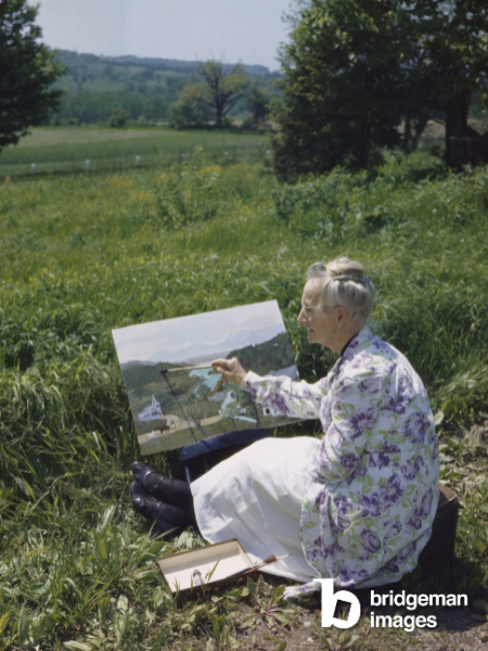 Grandma Moses painting in the garden in 1946 