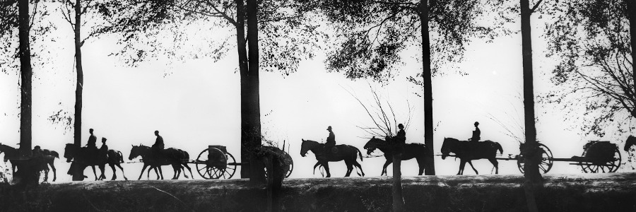 A view, in silhouette, of Australian artillery limbers loaded with ammunition proceeding along the Ypres Road, 25 September 1917 / Australian War Memorial / Bridgeman Images 